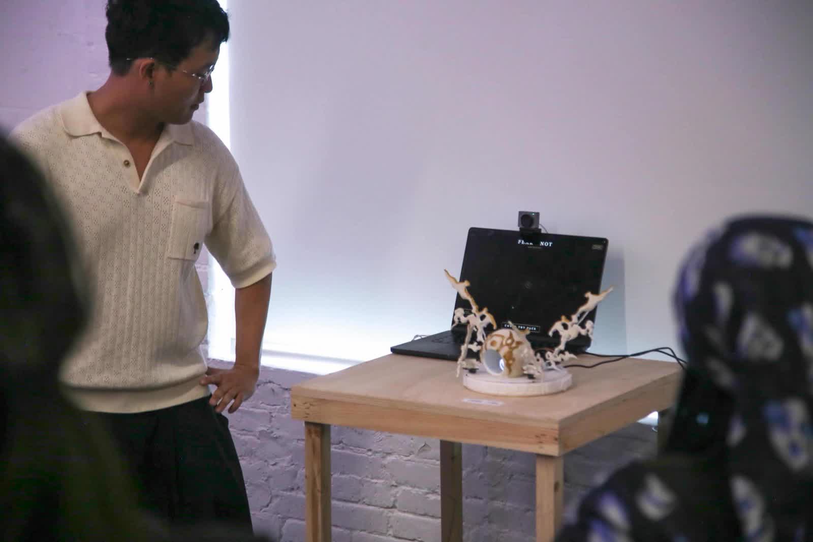 Viewer encountering The Witness at the exhibition, the sculpture's wings open as he looks at it